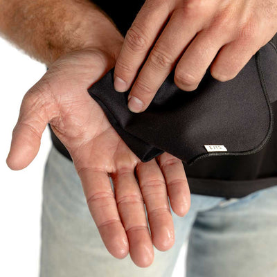 person wiping sweaty hands with Ejis sweat-absorbing handkerchief