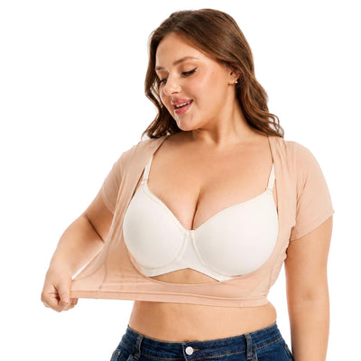 Woman stretching the bottom of a nude-colored Ejis sweat proof bustier with a background