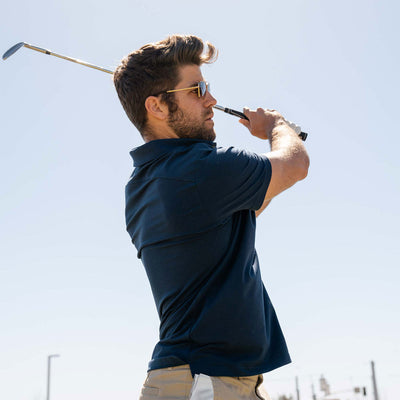 man swinging golf club with Ejis handkerchief in pocket