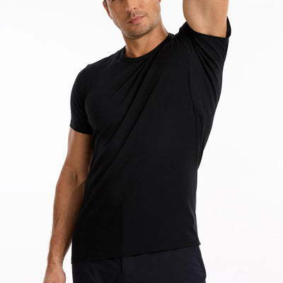 Man wearing a black TotalShield t-shirt with his arm raised over his head on a white background