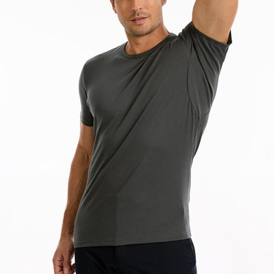 Man wearing a grey TotalShield t-shirt with his arm raised over his head on a white background