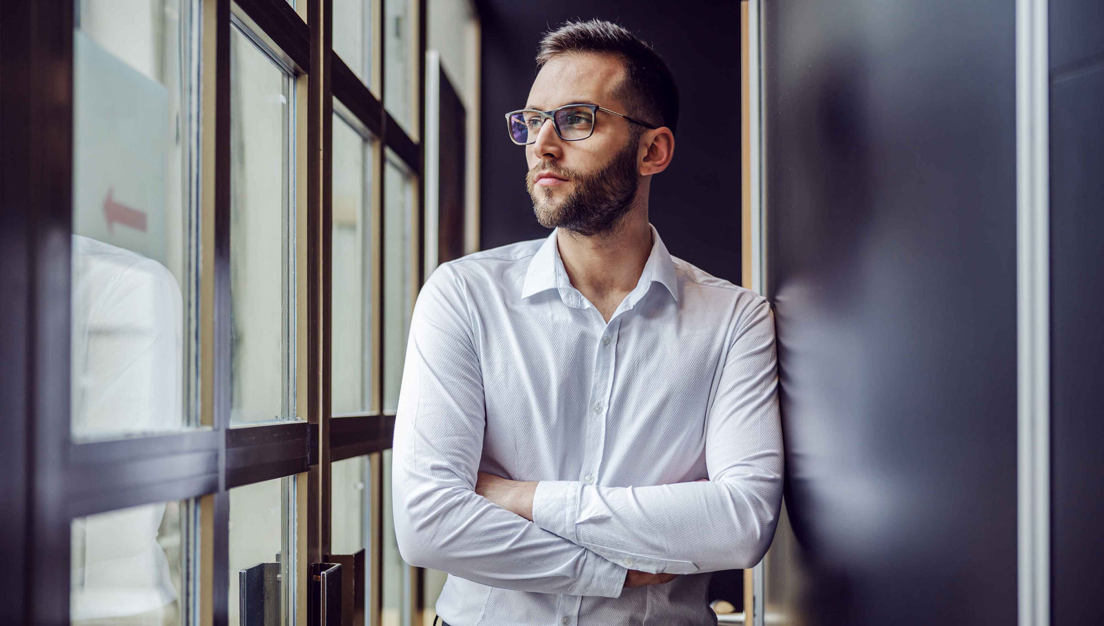 man looking out window sweating from anxiety