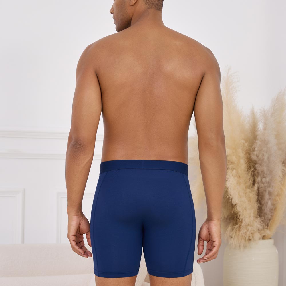 Man wearing Ejis navy sweat proof boxer briefs against a neutral background