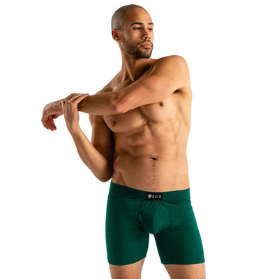 Man wearing green Ejis essential boxer briefs on a white background