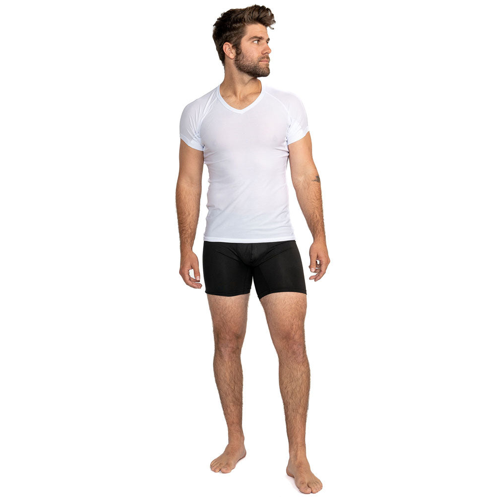 Man wearing white V-neck ultra breathable undershirt and black boxer briefs. Facing right on white background
